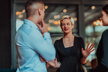 Image showing Photo of a business team of young people discussing business ideas in a modern urban environment. Selective focus