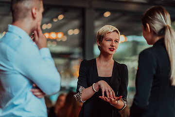 Image showing Photo of a business team of young people discussing business ideas in a modern urban environment. Selective focus