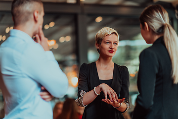 Image showing Photo of a business team of young people discussing business ideas in a modern urban environment. Selective focus