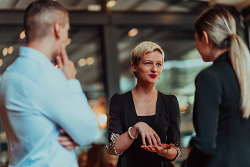 Image showing Photo of a business team of young people discussing business ideas in a modern urban environment. Selective focus