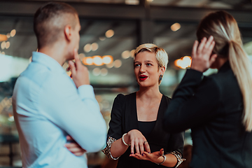 Image showing Photo of a business team of young people discussing business ideas in a modern urban environment. Selective focus