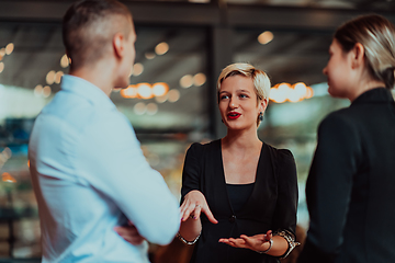 Image showing Photo of a business team of young people discussing business ideas in a modern urban environment. Selective focus