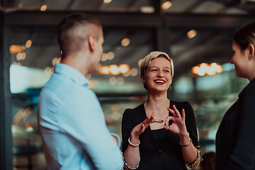 Image showing Photo of a business team of young people discussing business ideas in a modern urban environment. Selective focus