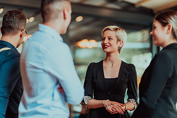 Image showing Photo of a business team of young people discussing business ideas in a modern urban environment. Selective focus