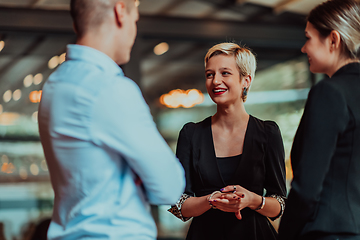 Image showing Photo of a business team of young people discussing business ideas in a modern urban environment. Selective focus