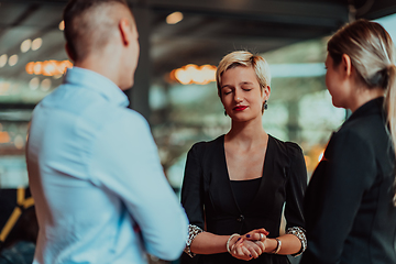 Image showing Photo of a business team of young people discussing business ideas in a modern urban environment. Selective focus