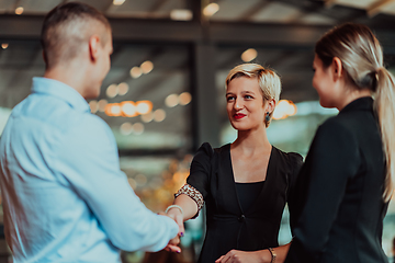 Image showing Photo of a business team of young people discussing business ideas in a modern urban environment. Selective focus