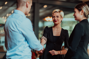 Image showing Photo of a business team of young people discussing business ideas in a modern urban environment. Selective focus