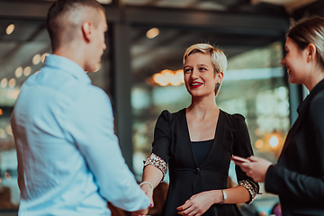 Image showing Photo of a business team of young people discussing business ideas in a modern urban environment. Selective focus