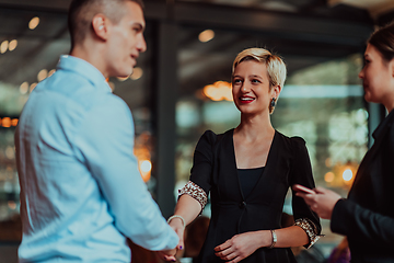 Image showing Photo of a business team of young people discussing business ideas in a modern urban environment. Selective focus