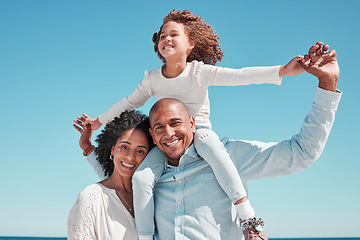 Image showing Family, smile and piggyback portrait on blue sky at beach on vacation, bonding and care at seashore. Holiday relax, summer and happy father, mother and kid or girl enjoying playing together outdoors.