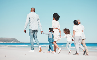 Image showing Family, grandparents and children walking on beach to relax on summer holiday, vacation and weekend. Happy, parents and back of mother, dad and kids holding hands for calm, bonding and quality time