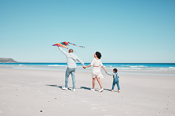 Image showing Holding hands, travel and family walking with kite together at a beach, relax and bond on ocean background. Flying, toy and couple with daughter at the sea, walk and enjoy trip in Miami with fun game