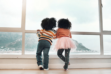 Image showing Window, looking and back of children with view of ocean, mountain and nature landscape from home. Childhood, relax and kids by glass waiting to play outdoors by sea on holiday, vacation and weekend