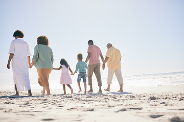 Image showing Family, walking on beach sand and holding hands, generations and people, grandparents with parents and kids. Together outdoor, unity and trust, travel to Bali with love, care and bond with back view