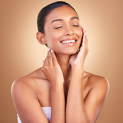 Image showing Beauty, skincare and touch with indian woman in studio for happy, spa treatment and facial. Cosmetics, self care and glow with model on brown background for satisfaction, empowerment and confidence