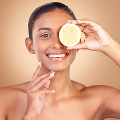 Image showing Skincare, woman portrait and lemon glow for health, wellness and beauty of a young model with happiness. Studio, smile and healthy fruit with vitamin c and fruits nutrition for facial and dermatology