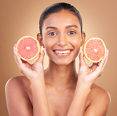 Image showing Skincare, woman smile portrait and grapefruit for health, wellness and beauty of a young model with happiness. Studio, detox and healthy fruit with vitamin c and nutrition for facial and dermatology