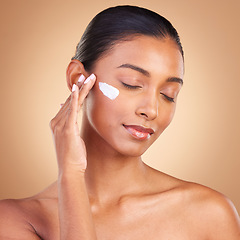 Image showing Beauty, skincare and face of Indian woman with cream in studio for wellness, glowing and spa products. Salon, dermatology and girl with lotion cosmetics, moisturizer makeup and anti aging products