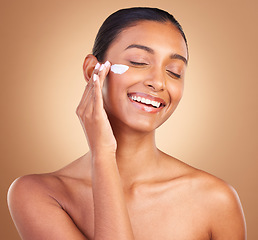 Image showing Skincare beauty, sunscreen and laugh of a happy woman with cosmetic and cream. Isolated, studio background and young model with a smile from face cleaning, cosmetics and dermatology facial product.