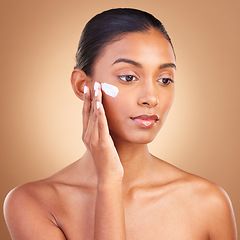 Image showing Skincare, sunscreen and natural beauty of a woman with cosmetic and spa cream. Isolated, studio background and young model with a glow from face cleaning, cosmetics and dermatology facial product