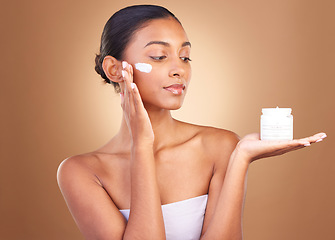 Image showing Skincare product, sunscreen and wellness of a relax woman with cosmetic and spa cream. Isolated, studio background and young model with beauty from face cleaning, cosmetics and dermatology facial