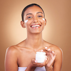 Image showing Indian woman, skincare cream and jar in hands for portrait, health and wellness by brown background. Young model, lotion product and studio with aesthetic, dermatology and clean with cosmetic beauty