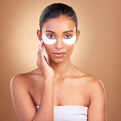 Image showing Beauty, eye patch and portrait of Indian woman in studio for facial, spa treatment and glow. Self care, cosmetics and hydration with female model on brown background for mask, product and youth