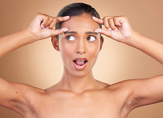 Image showing Beauty health, surprise and woman forehead wrinkles with a female squeeze face with shock. Isolated, studio background and cosmetic change of a model holding clean skin for plastic surgery