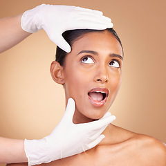 Image showing Woman, face and hands in plastic surgery for cosmetics, skincare or beauty against a studio background. Hand of surgeon or beautician with female in spa or facial treatment for medical procedure