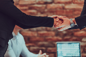 Image showing Business shaking hands, finishing up meeting. Successful businesspeople handshaking after good deal