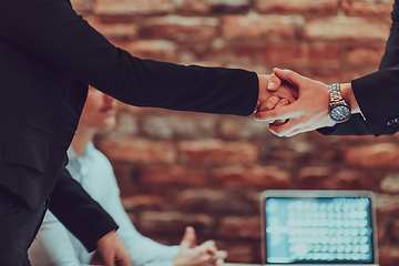 Image showing Business shaking hands, finishing up meeting. Successful businesspeople handshaking after good deal