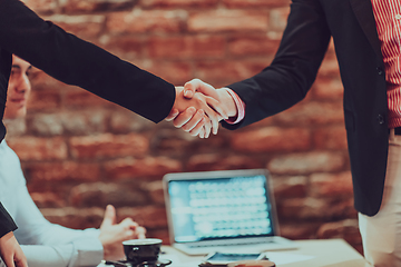 Image showing Business shaking hands, finishing up meeting. Successful businesspeople handshaking after good deal