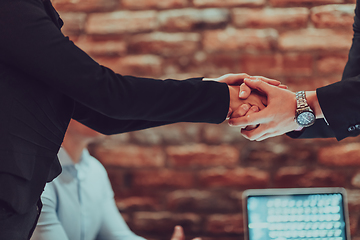 Image showing Business shaking hands, finishing up meeting. Successful businesspeople handshaking after good deal