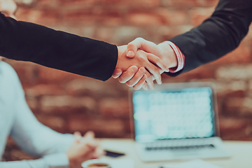 Image showing Business shaking hands, finishing up meeting. Successful businesspeople handshaking after good deal