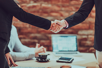 Image showing Business shaking hands, finishing up meeting. Successful businesspeople handshaking after good deal