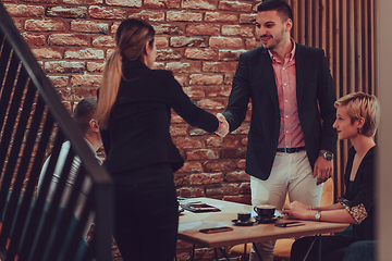 Image showing Business shaking hands, finishing up meeting. Successful businesspeople handshaking after good deal