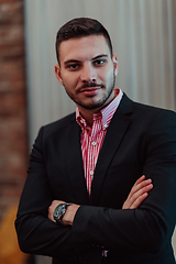 Image showing Portrait of a young businessman in a modern suit. Portrait of the company director in his office. Selective focus