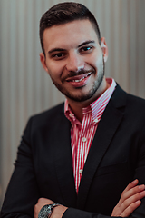 Image showing Portrait of a young businessman in a modern suit. Portrait of the company director in his office. Selective focus