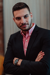 Image showing Portrait of a young businessman in a modern suit. Portrait of the company director in his office. Selective focus