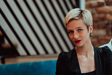 Image showing Pretty businesswoman, successful confidence in a modern coffe shop. Selective focus