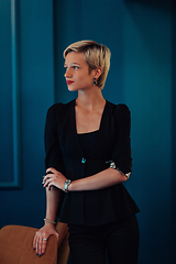 Image showing Blonde business woman, successful confidence on modern blue mat background. Selective focus