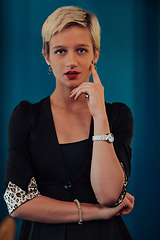 Image showing Blonde business woman, successful confidence on modern blue mat background. Selective focus