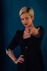 Image showing Blonde business woman, successful confidence on modern blue mat background. Selective focus