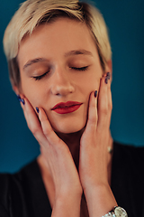 Image showing Photo Beautiful businesswoman, successful confident young woman posing with hands on face. Selective focus