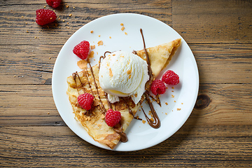 Image showing crepe with ice cream and raspberries