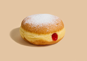 Image showing jelly donut on beige background