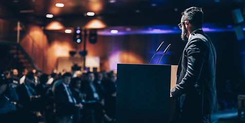 Image showing Speaker giving a talk on corporate business conference. Unrecognizable people in audience at conference hall. Business and Entrepreneurship event