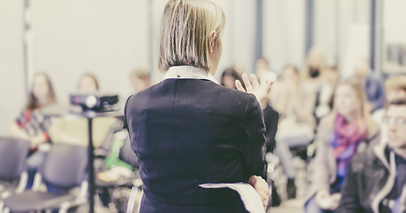 Image showing Female public speaker giving talk at Business Event.