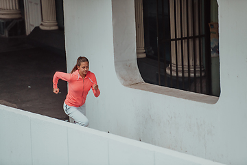 Image showing Women in sports clothes running in a modern urban environment. The concept of a sporty and healthy lifestyle